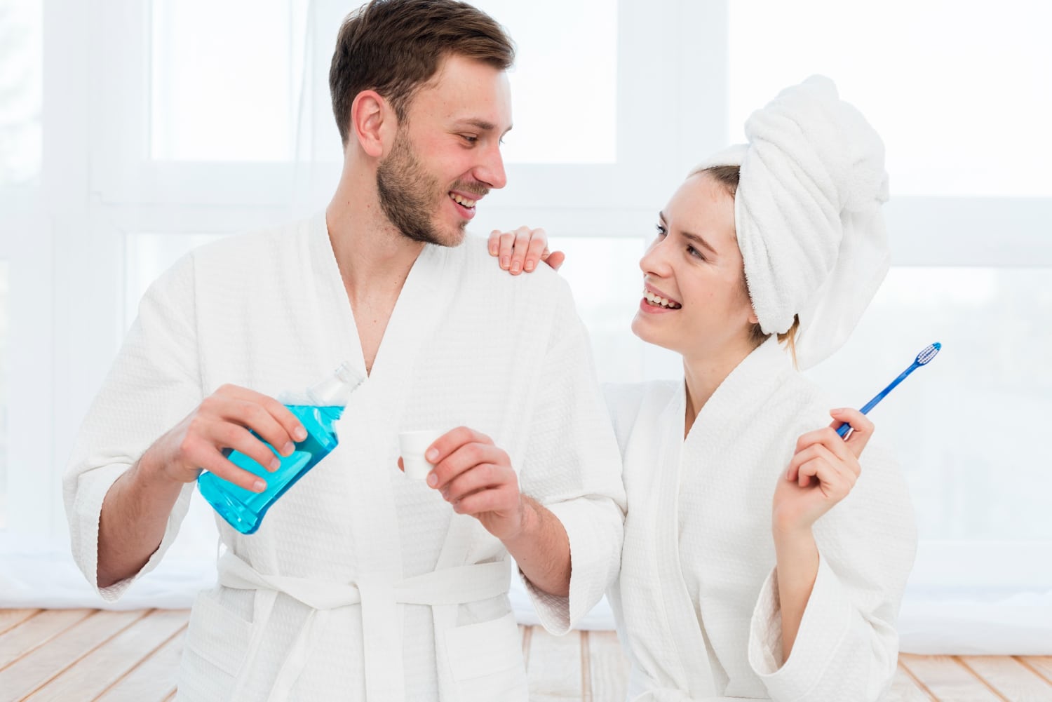front-view-couple-bathrobes-with-mouthwash-toothbrush1
