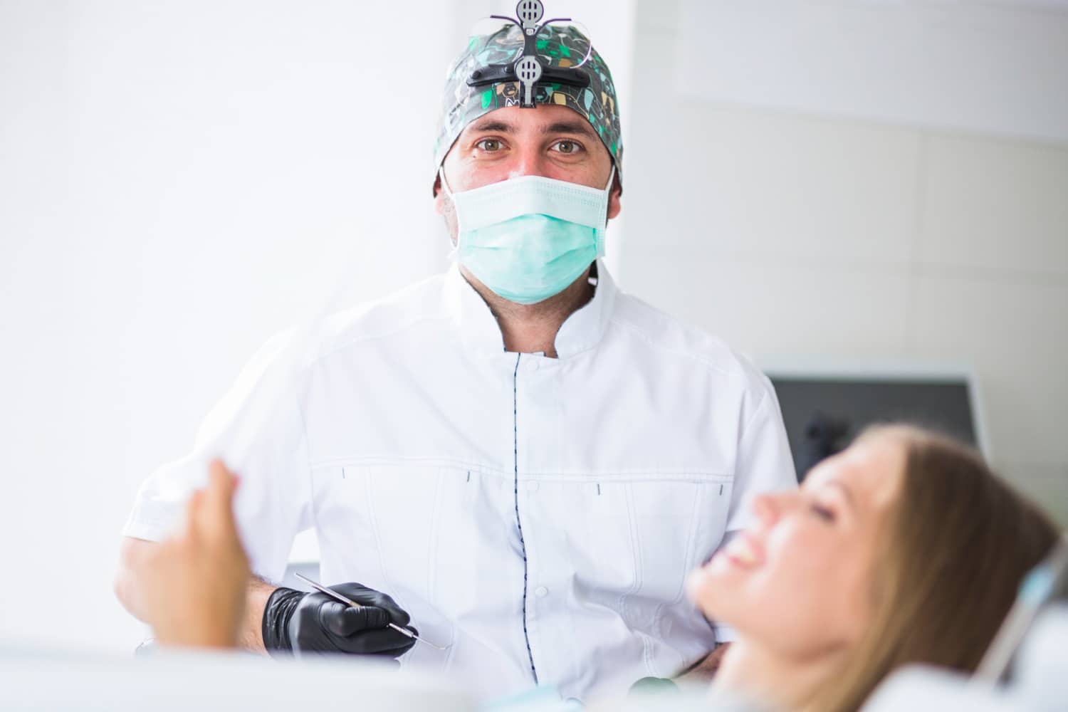 portrait-male-doctor-wearing-mask-treating-female-patient