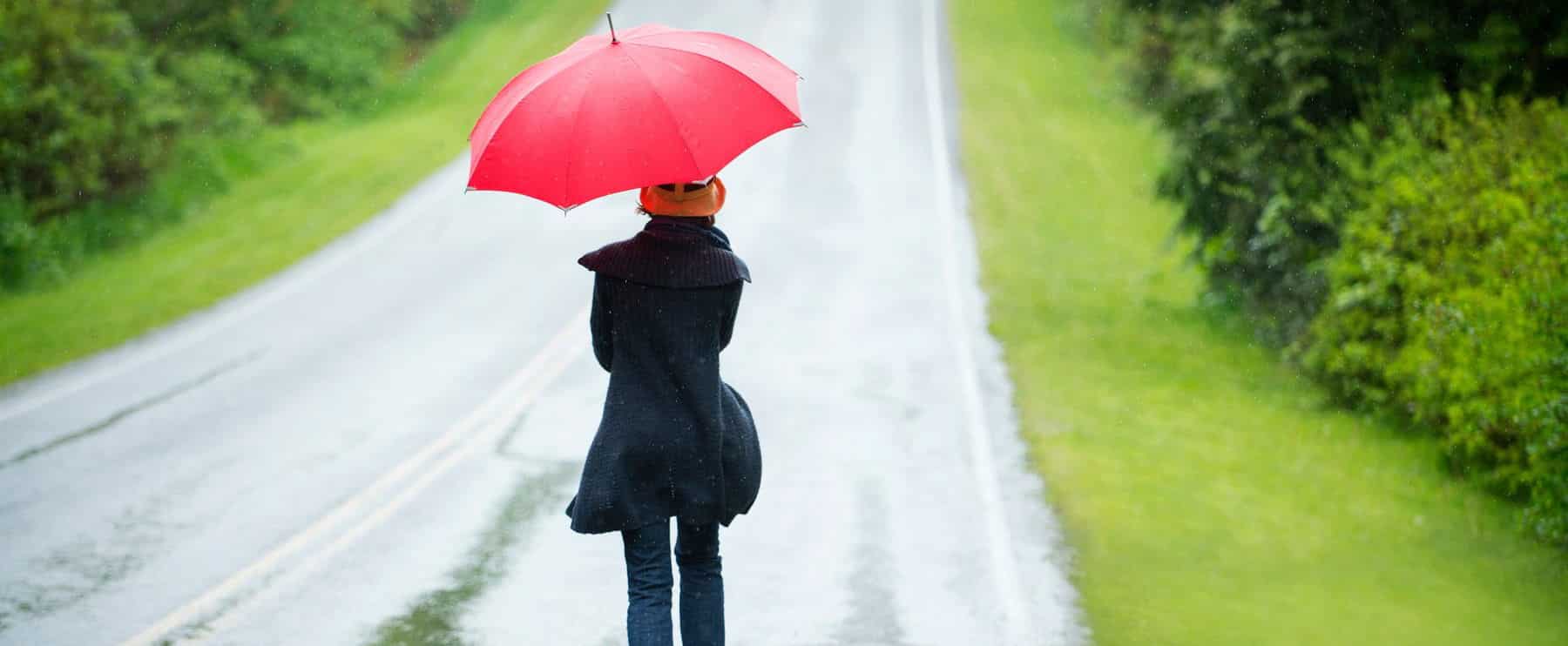 Woman On Empty Road With Red Umbrella